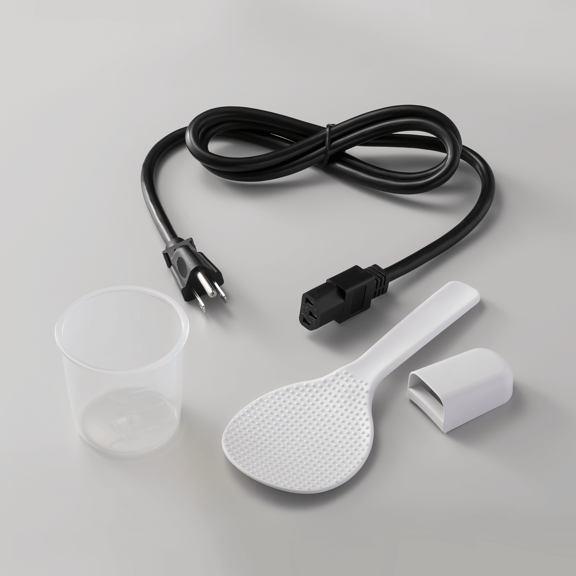 Accessories include rice measuring cup, spatula and spatula holder
