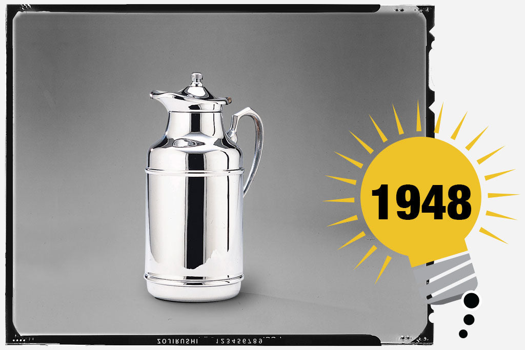 Black and white photo of the Zojirushi Pelican Pot. The unit has a polished stainless exterior with a shape that resembles a pelican. Photo is labeled with the year 1948.
