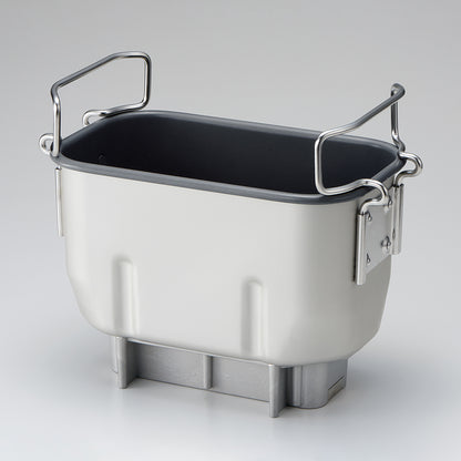 Breadmaker baking pan with handles on a light gray background
