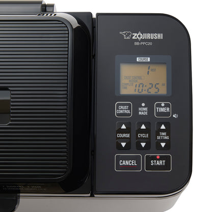Zojirushi breadmaker with digital display and control panel on a white background