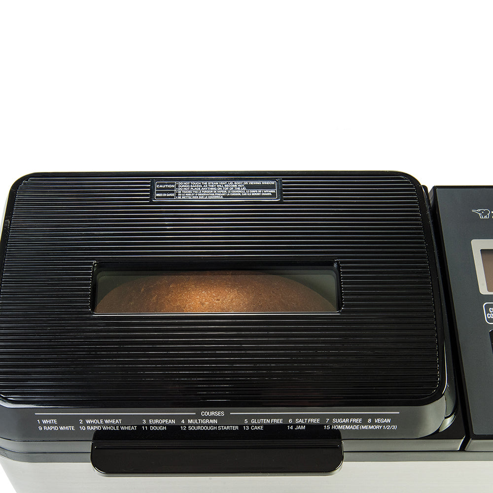 Breadmaker with a loaf of bread inside on a white background